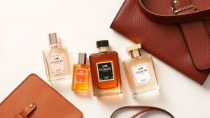 coach fragrance - Flat lay of Coach fragrance bottles in neutral tones with leather accessories an