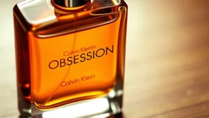 obsession cologne for men - Close-up of Calvin Klein Obsession cologne bottle with amber liquid, warm lighti